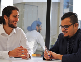 Two men in a conference room.